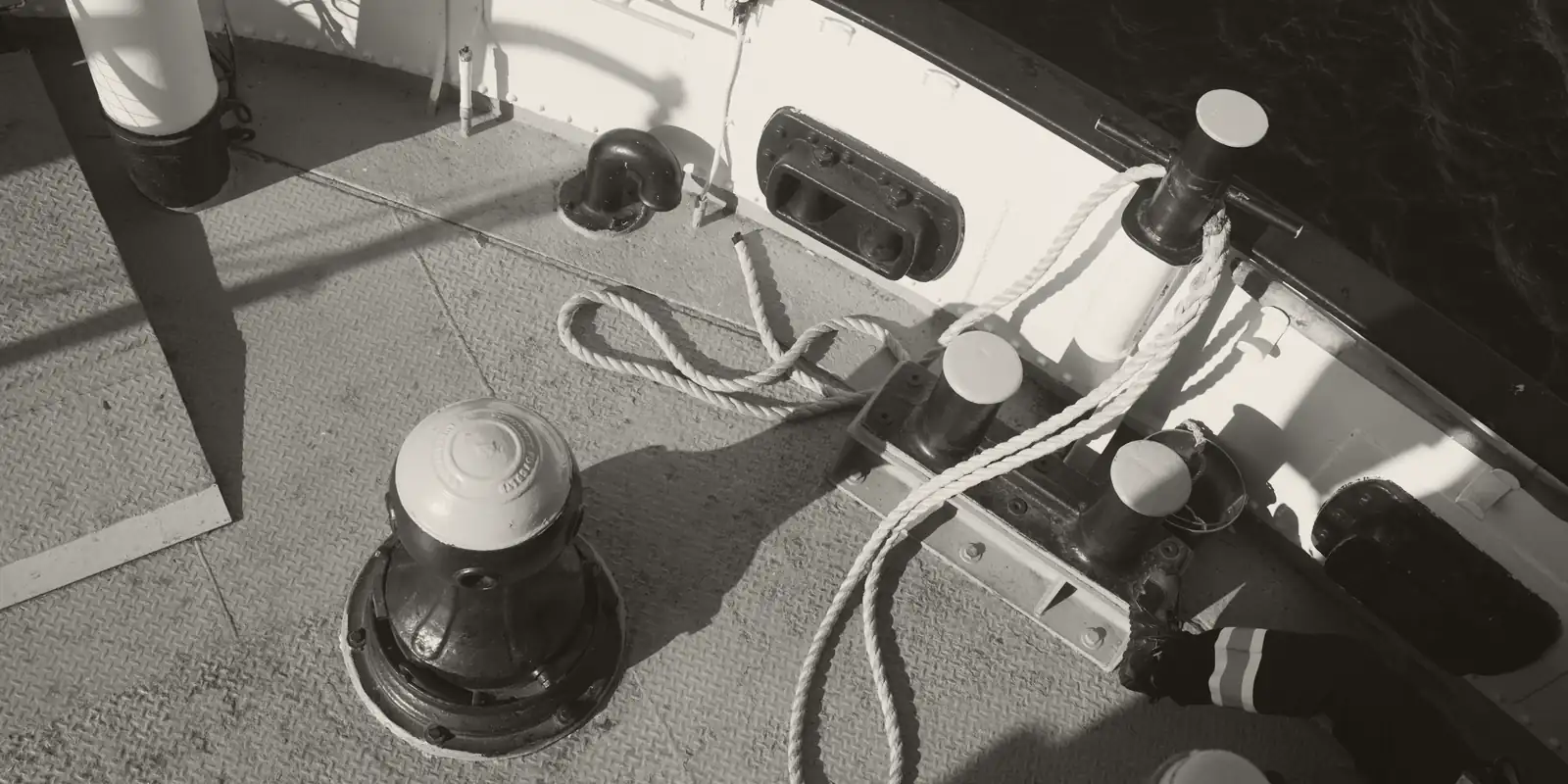 Mooring lines and bitts on the deck of a vessel.