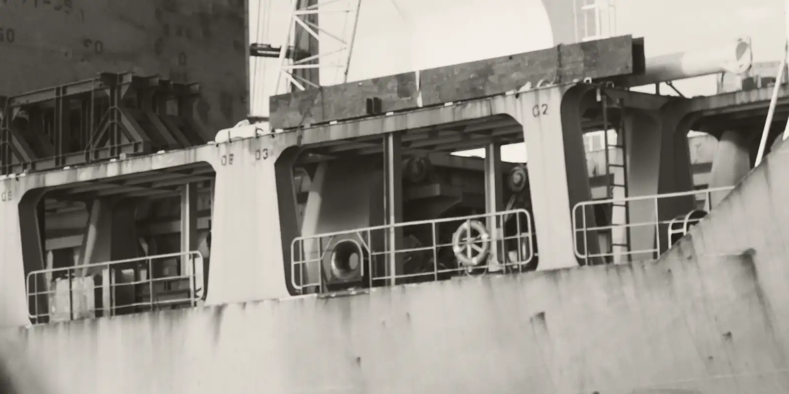 The side of a heavy-lift ship with project cargo stowed on deck.