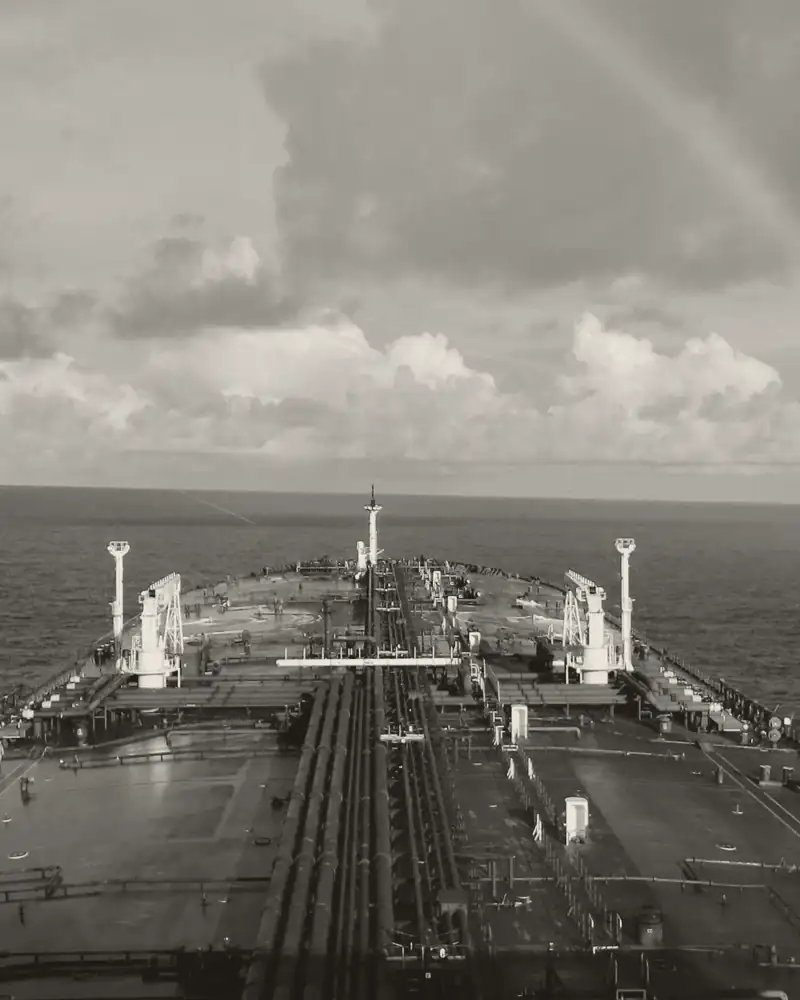 The deck of a tanker at sea, looking forward to the bow.